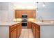 Kitchen features stainless steel appliances and light wood cabinets at 13814 Nighthawk Ter, Lakewood Ranch, FL 34202