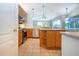 Kitchen with island, stainless steel appliances, and wood cabinets at 13814 Nighthawk Ter, Lakewood Ranch, FL 34202