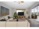 Spacious living room with sectional sofa and sliding doors leading to the patio at 13814 Nighthawk Ter, Lakewood Ranch, FL 34202