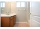 Well-lit bathroom with wood vanity, a shower/tub combo, and a tiled floor at 13814 Nighthawk Ter, Lakewood Ranch, FL 34202