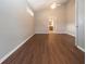 Serene bedroom with neutral walls, wood-look floors, and bathroom access at 13814 Nighthawk Ter, Lakewood Ranch, FL 34202