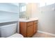 Clean bathroom with wood vanity, toilet, and built-in shelving at 13814 Nighthawk Ter, Lakewood Ranch, FL 34202