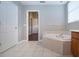 Bathroom features a corner soaking tub and access to bedroom at 13814 Nighthawk Ter, Lakewood Ranch, FL 34202