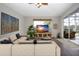 Spacious living room with sectional sofa and sliding doors leading to the patio at 13814 Nighthawk Ter, Lakewood Ranch, FL 34202