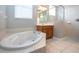 Bathroom boasts a corner soaking tub and shower at 13814 Nighthawk Ter, Lakewood Ranch, FL 34202