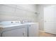 Laundry room with Whirlpool washer and dryer and additional storage at 13814 Nighthawk Ter, Lakewood Ranch, FL 34202