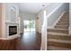 Living room with fireplace, stairs, and pool view at 13814 Nighthawk Ter, Lakewood Ranch, FL 34202