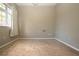 Empty bedroom with new carpet, neutral walls, and window with curtains at 13814 Nighthawk Ter, Lakewood Ranch, FL 34202