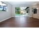 Gathering room with sliding doors to pool and view of the backyard at 13814 Nighthawk Ter, Lakewood Ranch, FL 34202