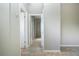 Hallway with neutral walls, carpet, and doors to bedrooms and bathrooms at 13814 Nighthawk Ter, Lakewood Ranch, FL 34202