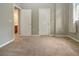 Spacious bedroom with neutral walls and carpeting, featuring two closets and access to a bathroom at 13814 Nighthawk Ter, Lakewood Ranch, FL 34202