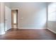 Empty bedroom with new wood-look flooring and door to hallway at 13814 Nighthawk Ter, Lakewood Ranch, FL 34202