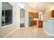 Dining room with tile floor and view into kitchen and pool at 13814 Nighthawk Ter, Lakewood Ranch, FL 34202