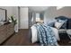 Main bedroom with a dresser and a queen-size bed at 13814 Nighthawk Ter, Lakewood Ranch, FL 34202