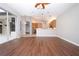 Gathering room with dark wood floors, open to kitchen and pool view at 13814 Nighthawk Ter, Lakewood Ranch, FL 34202