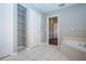 Bathroom with soaking tub and walk-in closet access at 13814 Nighthawk Ter, Lakewood Ranch, FL 34202