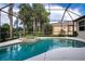 Relaxing pool and spa with screened enclosure, offering serene lake views at 13814 Nighthawk Ter, Lakewood Ranch, FL 34202