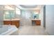 Bathroom with double vanity, soaking tub, and shower at 13814 Nighthawk Ter, Lakewood Ranch, FL 34202
