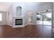 Spacious living room featuring a fireplace and sliding glass doors to the pool at 13814 Nighthawk Ter, Lakewood Ranch, FL 34202