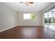 Gathering room with dark wood flooring and sliding doors to the pool at 13814 Nighthawk Ter, Lakewood Ranch, FL 34202