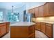 Kitchen with stainless steel refrigerator and wood cabinets at 13814 Nighthawk Ter, Lakewood Ranch, FL 34202