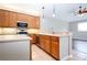 Eat-in kitchen with stainless steel appliances and wood cabinets at 13814 Nighthawk Ter, Lakewood Ranch, FL 34202