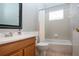 Clean bathroom with tub shower combo, wood vanity, and updated fixtures at 13814 Nighthawk Ter, Lakewood Ranch, FL 34202
