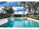 Refreshing screened pool and spa with a serene lake view at 13814 Nighthawk Ter, Lakewood Ranch, FL 34202