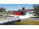 Modern red boat house with a metal roof near the waterfront at 416 Hacienda St, North Port, FL 34287