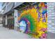 Colorful mural on the side of a building, featuring beach scene and tropical flowers at 416 Hacienda St, North Port, FL 34287