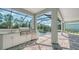 Outdoor kitchen with stainless steel appliances and a view of the pool at 21281 Holmes Cir, Venice, FL 34293