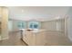 Modern kitchen island with white cabinets, quartz countertops, and stainless steel appliances at 21281 Holmes Cir, Venice, FL 34293