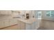Modern kitchen with white cabinets, center island, and stainless steel appliances at 21281 Holmes Cir, Venice, FL 34293