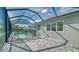 Screened-in pool and spa with a view of the backyard at 21281 Holmes Cir, Venice, FL 34293