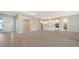 Open floorplan with kitchen, living, and dining areas, featuring tile floors and neutral colors at 21281 Holmes Cir, Venice, FL 34293