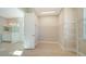 Spacious walk-in closet with custom shelving and direct access to bathroom at 21281 Holmes Cir, Venice, FL 34293