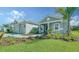 Two-car garage home with paver driveway and landscaping at 21281 Holmes Cir, Venice, FL 34293