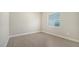 Simple bedroom with tile floors and a window with blinds at 21281 Holmes Cir, Venice, FL 34293