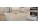 Large kitchen island with sink, quartz countertop, and seating space at 21281 Holmes Cir, Venice, FL 34293