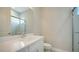 Modern bathroom with white vanity, tile shower and a large mirror at 21281 Holmes Cir, Venice, FL 34293