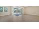 Gathering room with sliding glass doors opening to a pool and screened patio at 21281 Holmes Cir, Venice, FL 34293