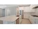 Modern kitchen with white cabinets, quartz countertops, and stainless steel appliances at 21281 Holmes Cir, Venice, FL 34293