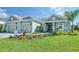 Two-car garage home with paver driveway and landscaping at 21281 Holmes Cir, Venice, FL 34293