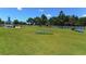 Dog park with agility equipment, shaded seating, and grassy areas at 21281 Holmes Cir, Venice, FL 34293