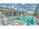 Resort-style pool and spa with screened enclosure at 21281 Holmes Cir, Venice, FL 34293