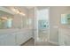Elegant bathroom with dual vanities and access to bedroom and closet at 21281 Holmes Cir, Venice, FL 34293
