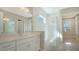 Modern bathroom with white tile, a walk-in shower, and dual vanity at 21281 Holmes Cir, Venice, FL 34293