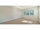 Well-lit bedroom featuring tile floors and a large window at 21281 Holmes Cir, Venice, FL 34293