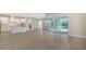 Open kitchen with white cabinets, island, and tile floors at 21281 Holmes Cir, Venice, FL 34293