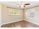 Spacious bedroom featuring wood-look floors, two windows, and a ceiling fan at 2714 21St W St, Bradenton, FL 34205